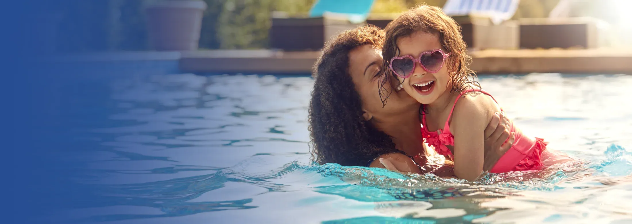 mother and daughter playing in pool